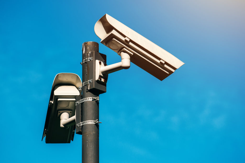 CCTV camera, modern era anti-terrorist electronic surveillance security cameras against blue sky that symbolizes freedom